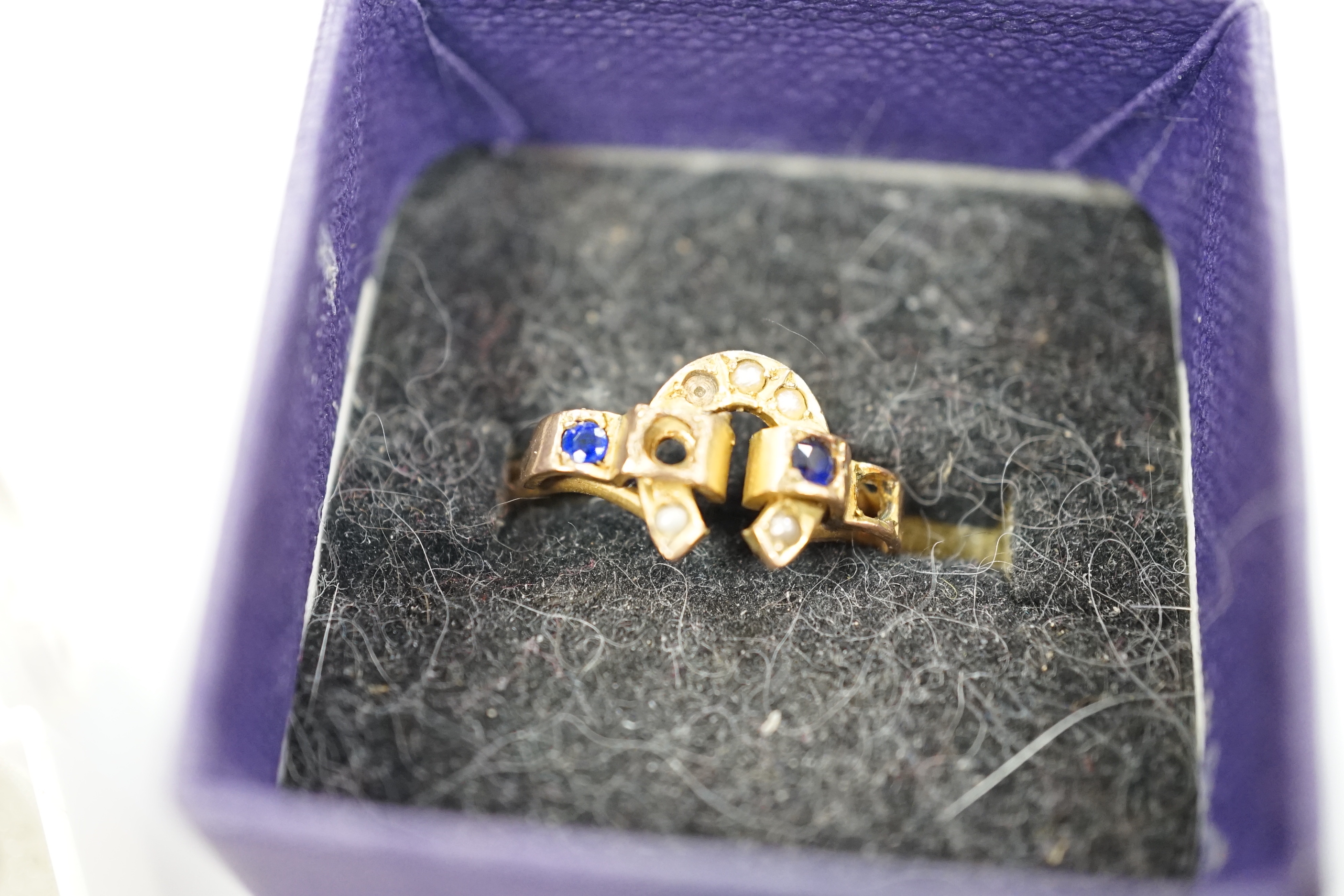 A small quantity of assorted jewellery including a late Victorian silver name brooch 'Polly', 42mm, a late Victorian 9ct gold and gem set horseshoe ring (stones missing), a late Victorian silver and carnelian set signet